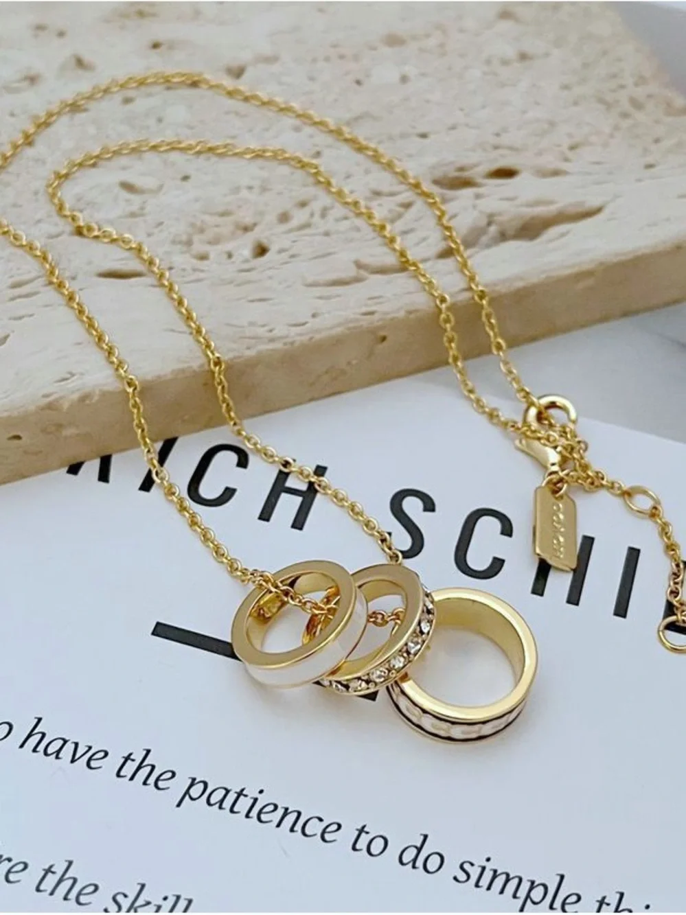 Coach Gold Necklace with White and Black Enamel Ring Pendants